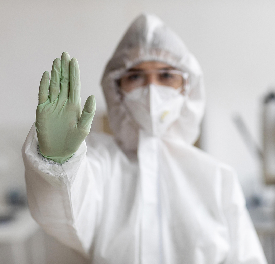 People wearing protective equipment disinfecting dangerous area